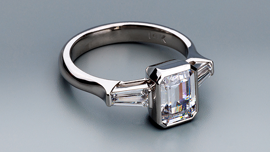 Learn fancy-shape stone setting engineering for faceted bezel, V-prong, and bar channel tapered baguette settings. Create a three-stone ring with cubic zircona, synthetic corundum or spinel, or your own gemstones.